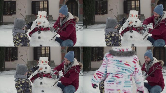 陪孩子一起堆雪人的父亲