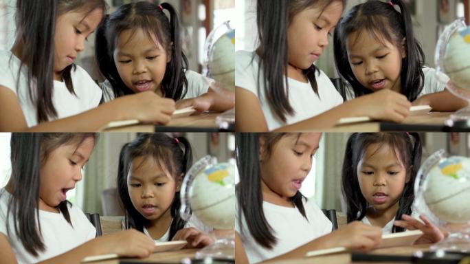 两个小女孩在家做家庭作业。