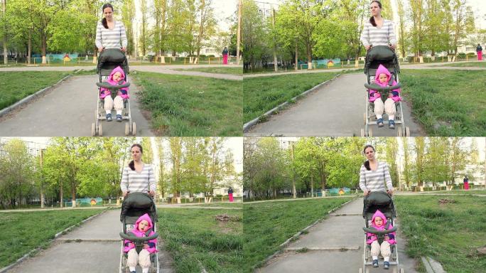 妈妈推着婴儿车的女婴在公园散步。