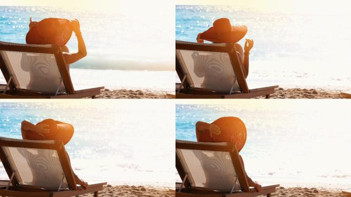 夏日女子躺在沙滩上的躺椅上