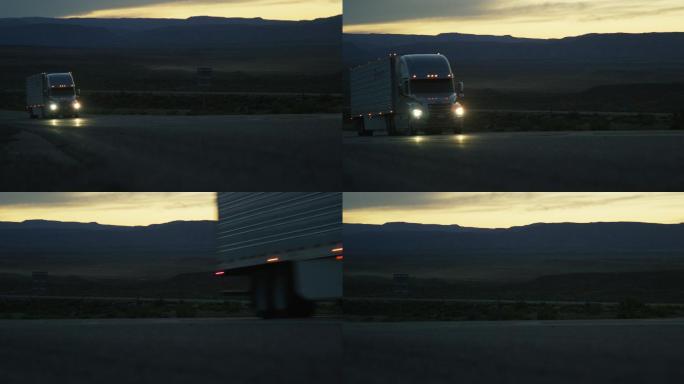 一辆开着头灯的半卡车行驶在路上