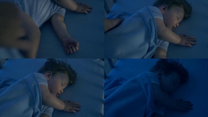 可爱的婴儿安静地睡在婴儿床上