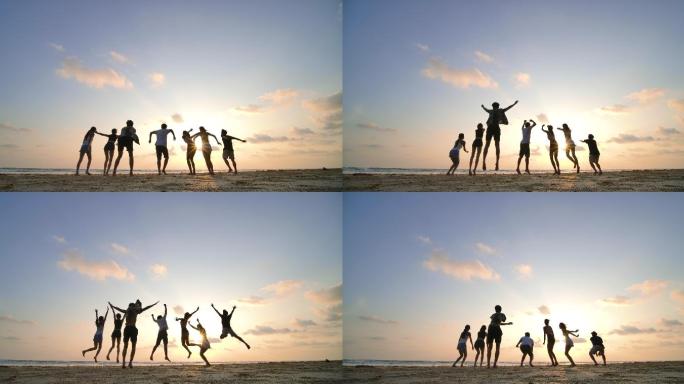 日落时分，朋友们在沙滩上跳起的剪影