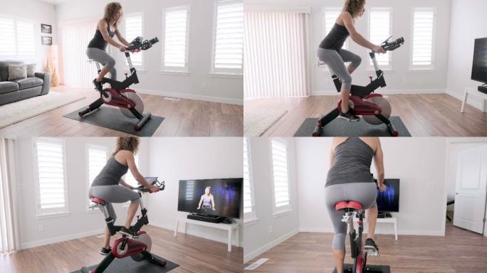在家里骑动感单车锻炼的女人