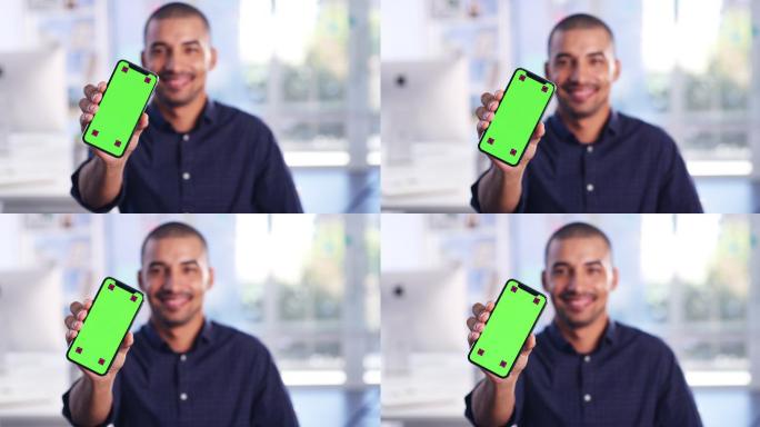 年轻人拿着一部绿色屏幕的手机