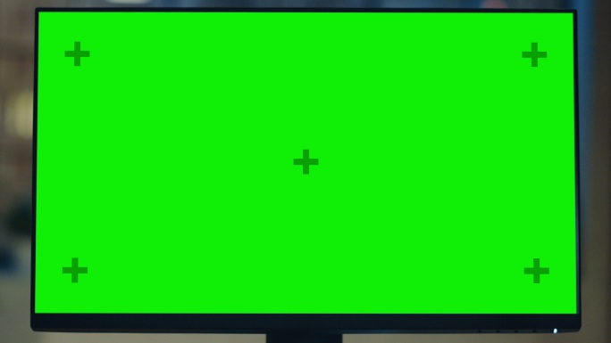 办公桌上摆放着一台绿色模拟屏幕的台式电脑