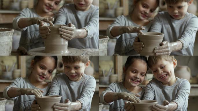 一对可爱的小学生在纺车上试着做陶器
