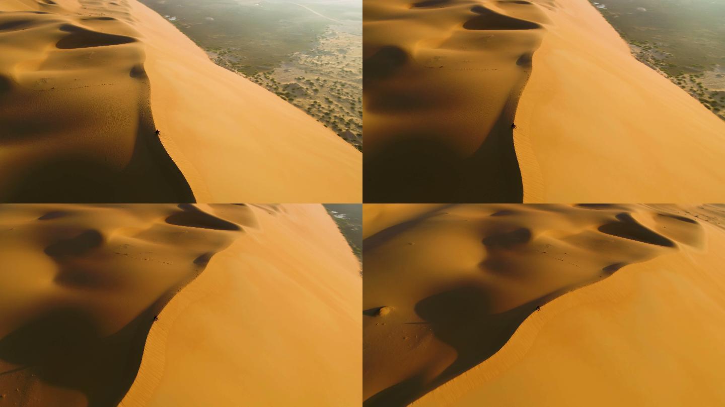 坐在沙丘边缘的人的鸟瞰图