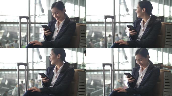 女商人在机场候机室使用智能手机
