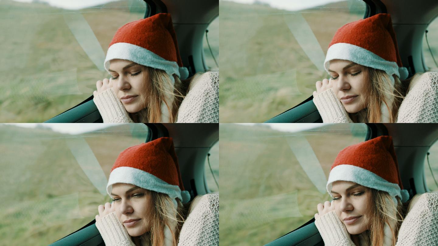 头戴圣诞帽睡在汽车后座的女人