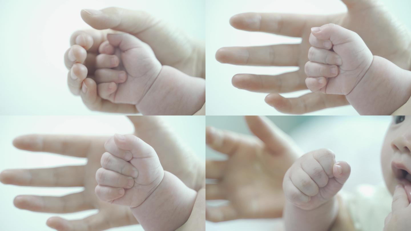 握着婴儿小手，大手和小手特写，母婴。