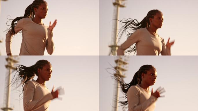 女运动员在体育场里奔跑