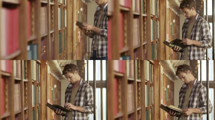 年轻人在图书馆翻阅一本书
