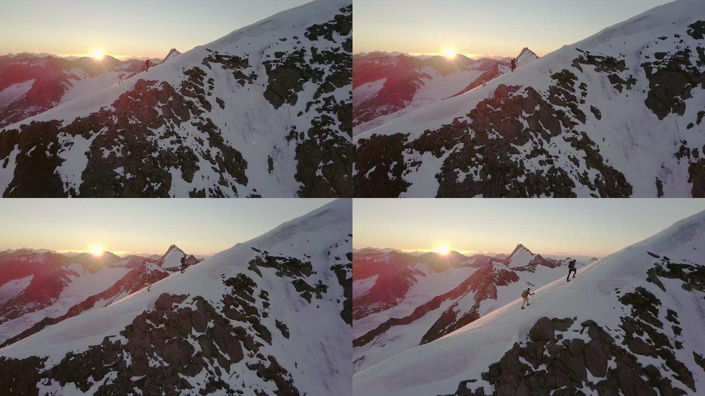 日出时登山者到达山顶的鸟瞰图