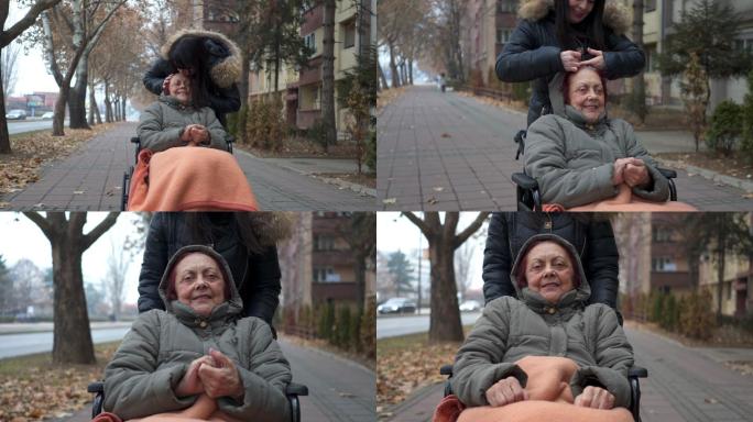 女儿亲吻坐轮椅的母亲