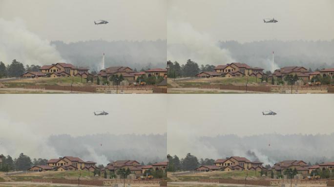 一架直升机在起火的房屋上空扑火