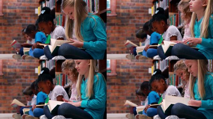 坐在一排的学生在图书馆看书