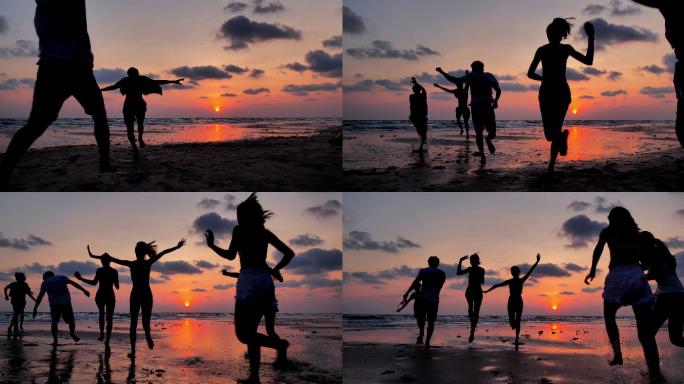 在沙滩奔跑的剪影海洋女性友谊日落