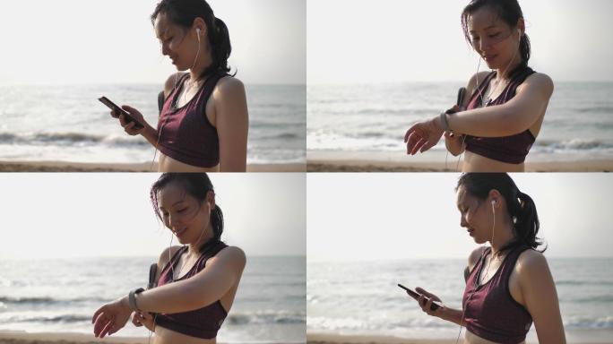 在沙滩上使用智能手表和智能手机的女性
