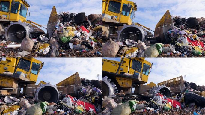 一辆垃圾掩埋车将一堆大垃圾运走的低视图。