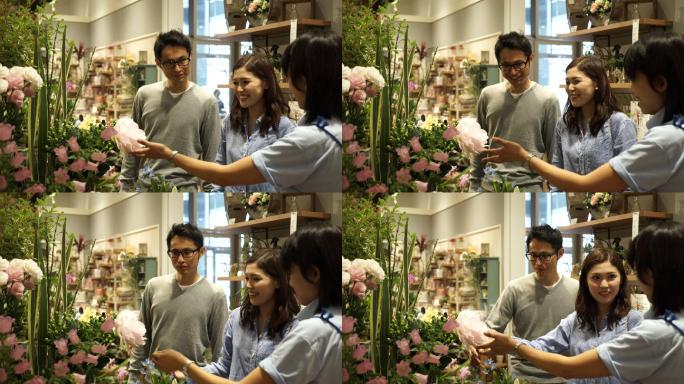 年轻夫妇在花店买花