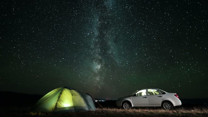 银河在夜晚的露营上空旋转