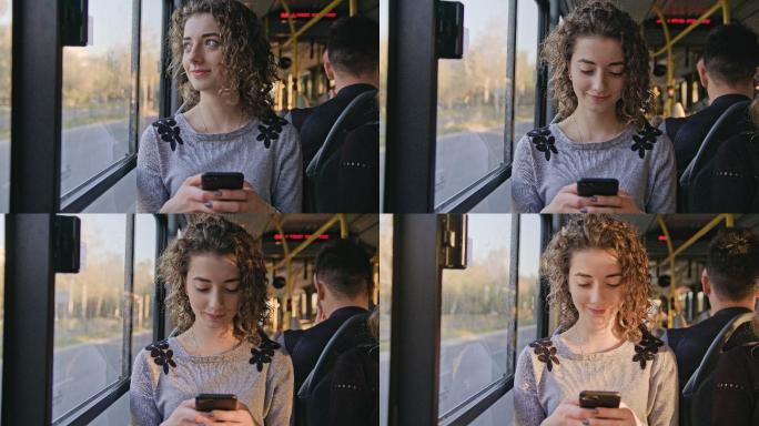 一位年轻女士在公共汽车上使用智能手机