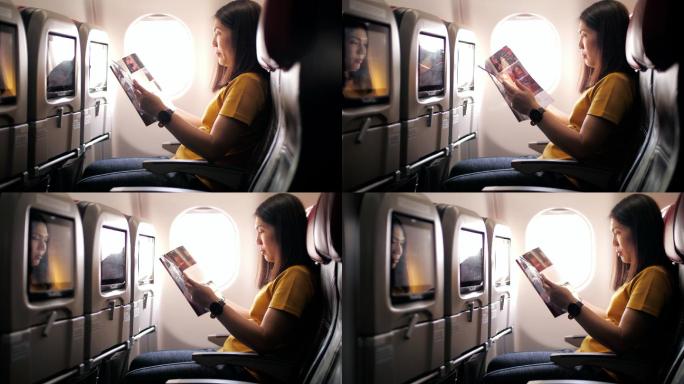 女乘客在飞机上读杂志和放松
