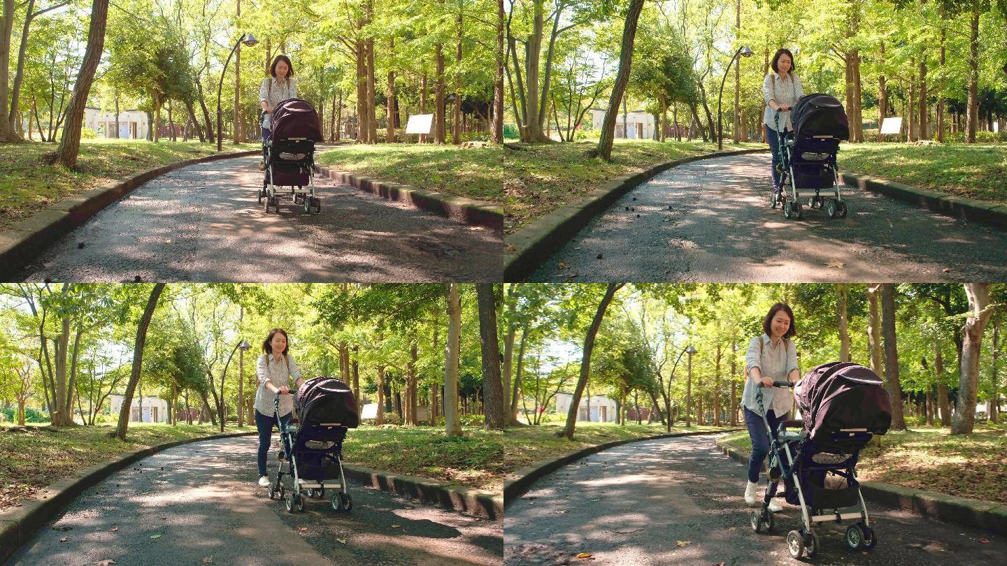 母亲推着婴儿车在公园散步