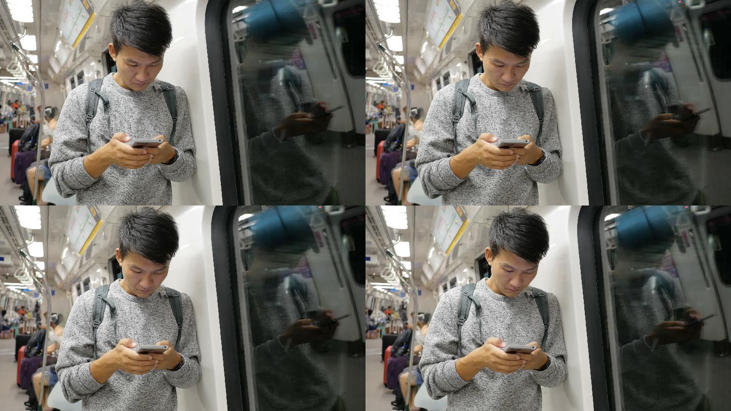 地铁里玩手机的人