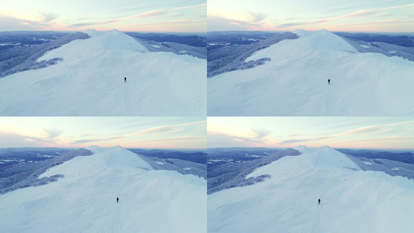 一个人独自在雪山山地上行走