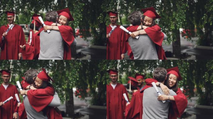 即将毕业的学生抱着她慈爱的父亲