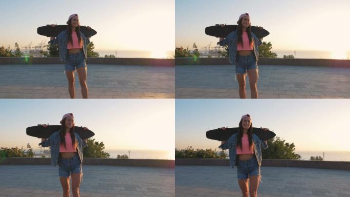 日落或日出时手持滑板的女子肖像