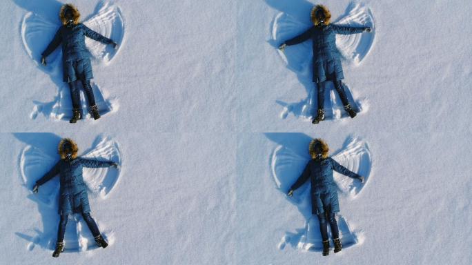女人在雪地里做雪天使
