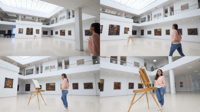女画家快速地穿过画廊来到画架前