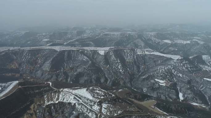 航拍雪后的陕北高原白雪覆盖的山林