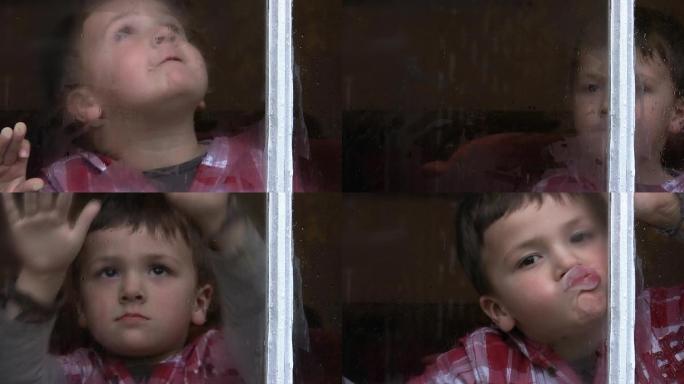 雨天窗边的孩子擦玻璃无聊
