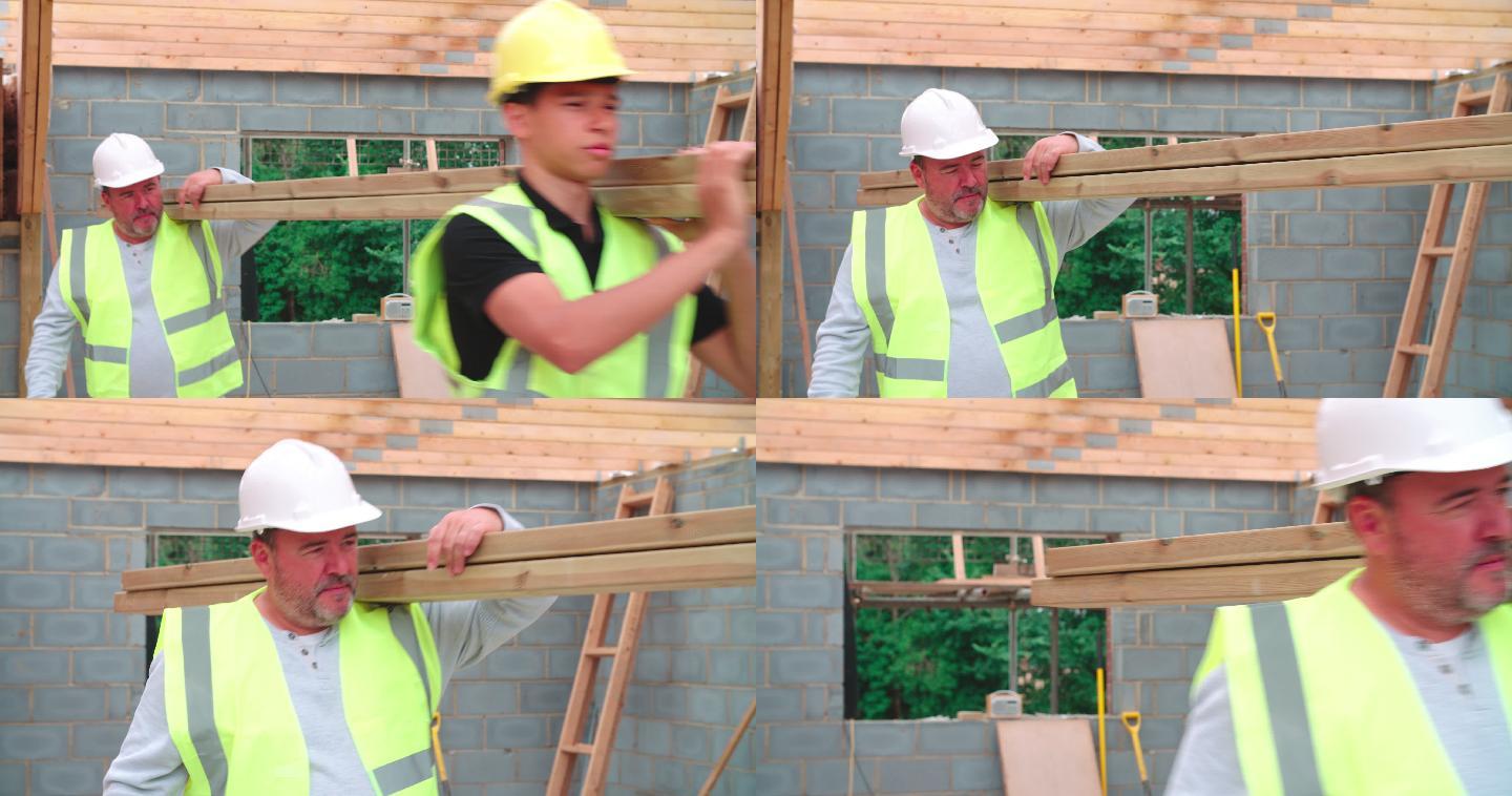 建筑工人和学徒在施工现场搬运木材