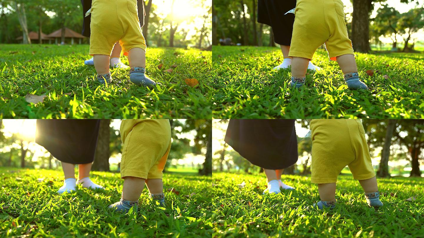 婴儿在草地上学习走路