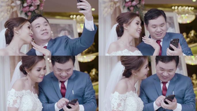 新婚夫妇用智能手机拍照自拍