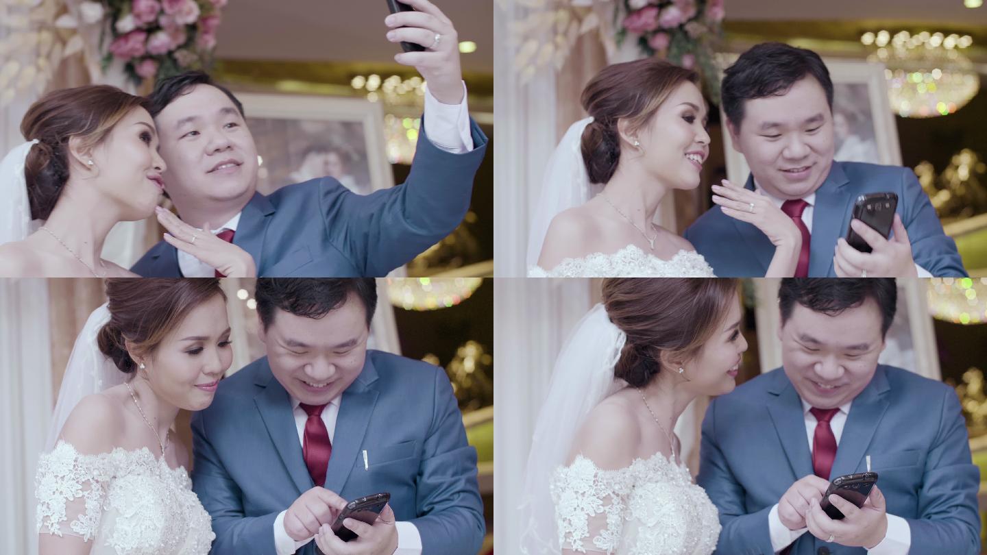 新婚夫妇用智能手机拍照自拍