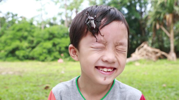 一个男孩在玩耍一只甲虫