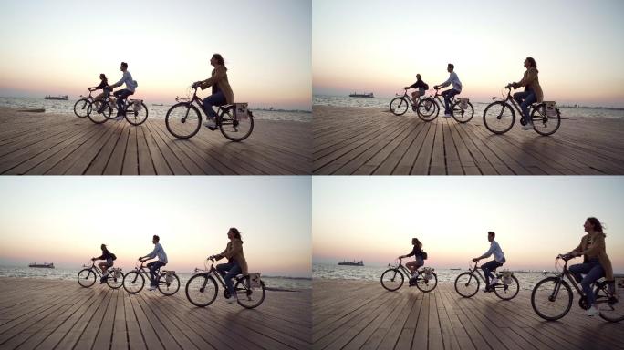 在海边骑自行车的三个人