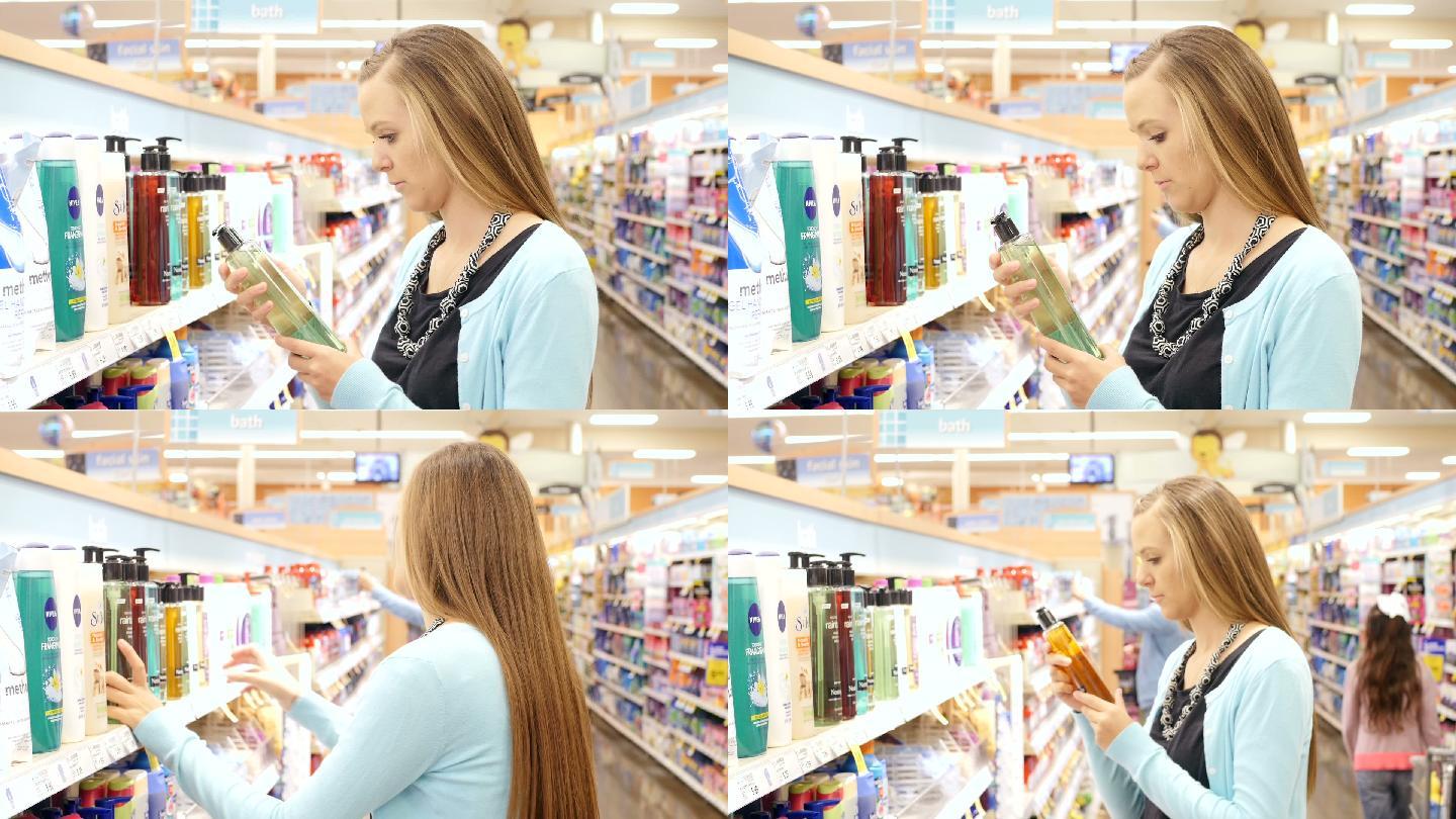 年轻的妇女在超市的个人护理走道里买沐浴露