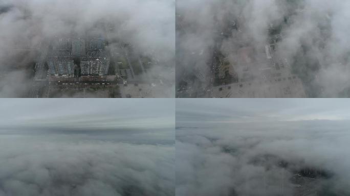 航拍透过云层看云雾中的城市