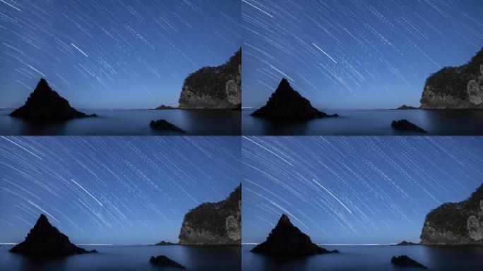日本伊豆半岛海岩夜空的时间点星迹镜头