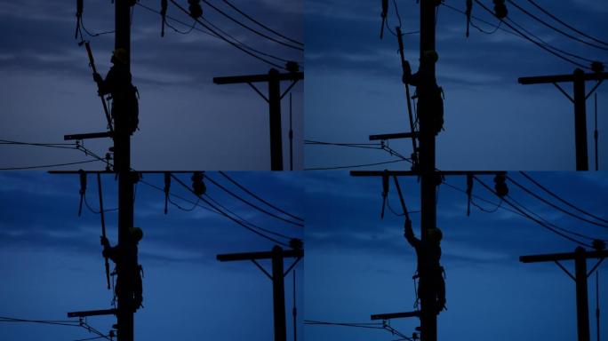夜晚电工线路工修理工在电线杆上攀爬作业