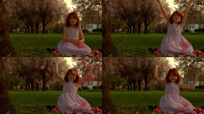 在草地上洒花的小女孩