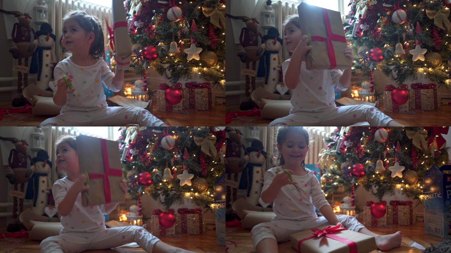 兴奋的孩子在圣诞节早晨打开礼物