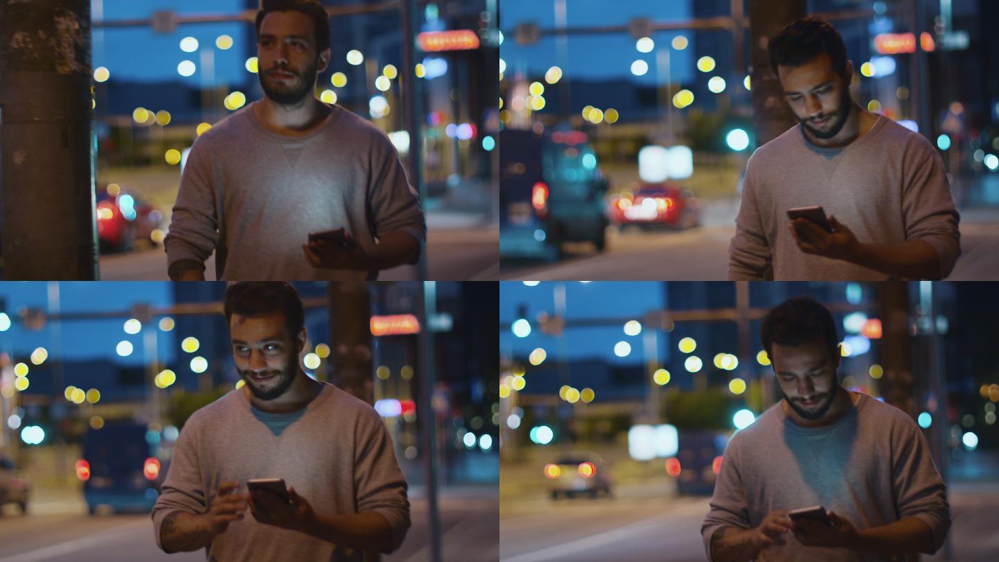 在夜晚的街道上用手机的帅哥。